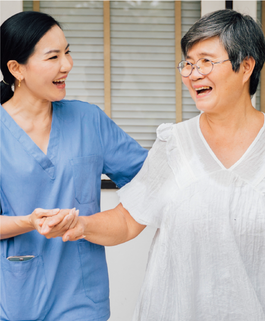 A female nurse helping a elderly patient