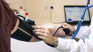 Healthcare worker taking blood pressure 