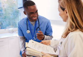 A male nurse and female doctor smiling