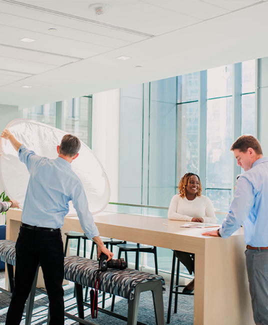 Coworkers standing looking over a computer