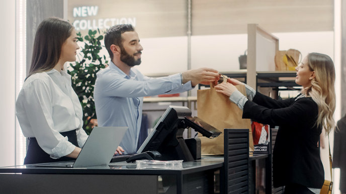 Customers making a purchase at a counter