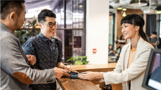 Two people paying at a retail store