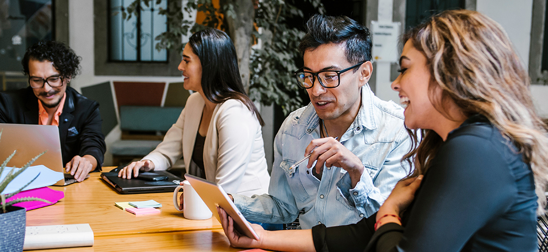 A group of people working together at a table 