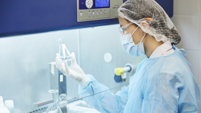 Female scientist in lab with beaker 