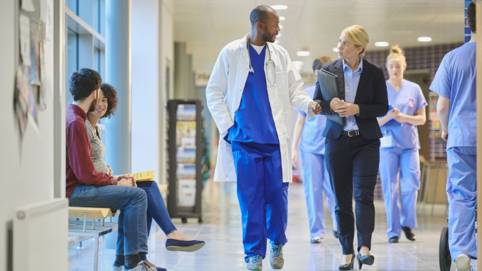 Doctors and nurses walking down a hallway in hospital 