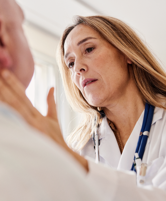 Doctor examining patient neck with her hands