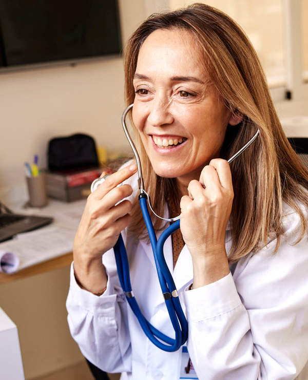 Woman in labcoat smiling at coworker