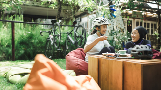 Two individuals enjoying tea outside