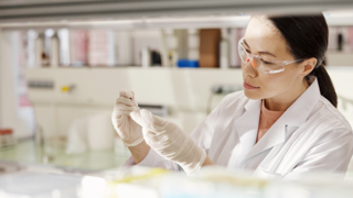 Woman in lab coat doing testing 