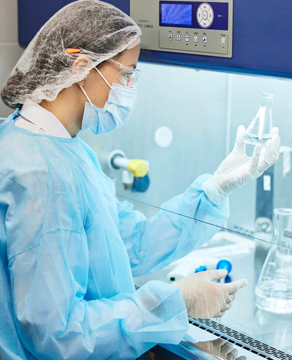 Scientist checking beakers containing liquids 