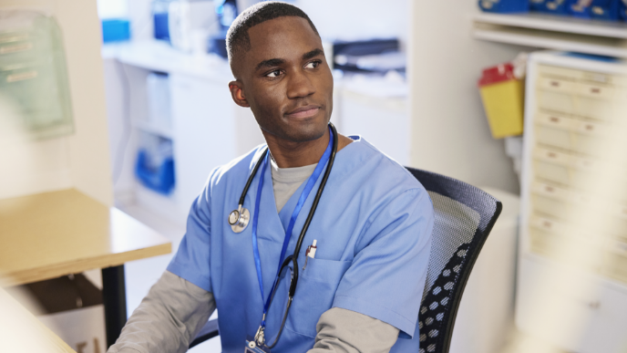 Male nurse sitting at desk