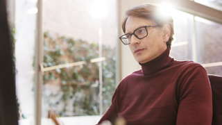 Man with glasses sitting at desk