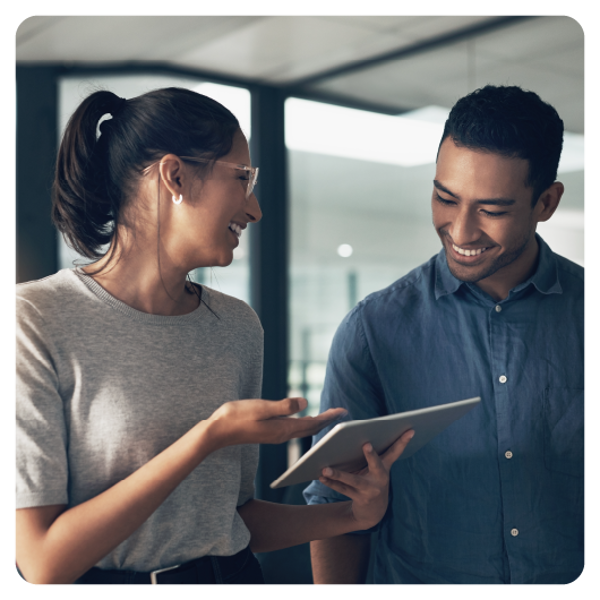 Photo of two people looking at a tablet