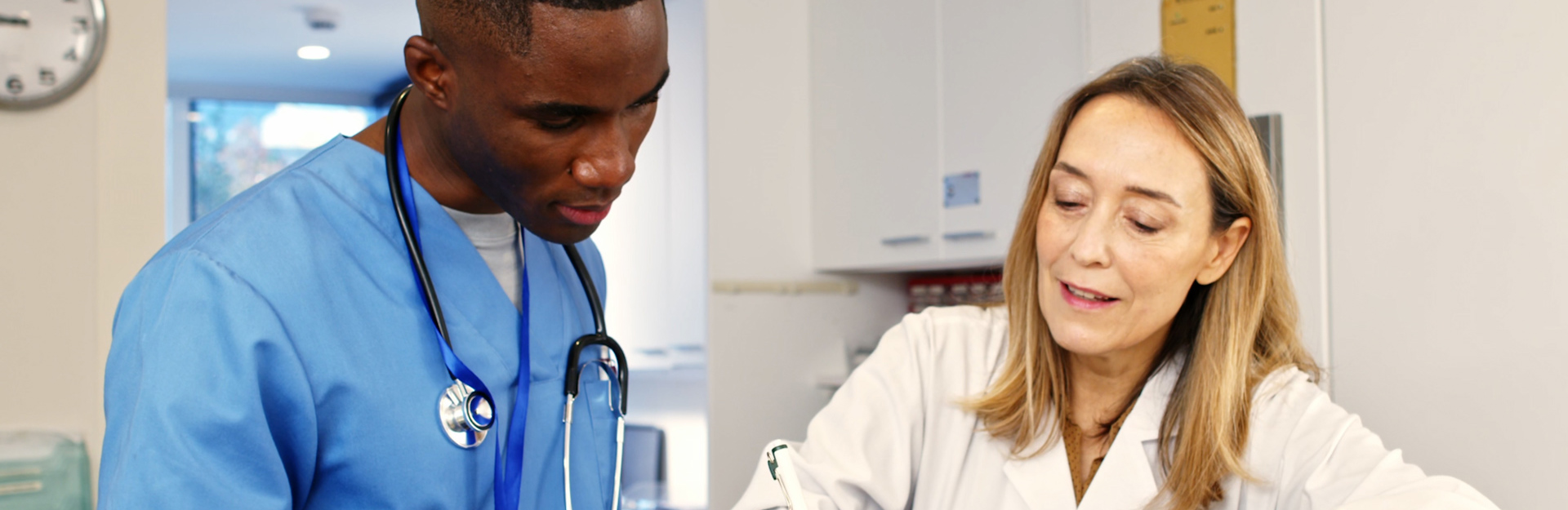 Photo of a nurse and doctor looking at a patient chart