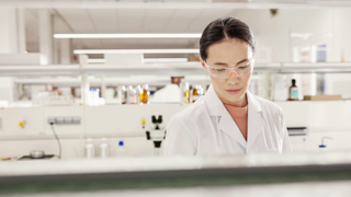 Female scientist in lab with safety glasses 