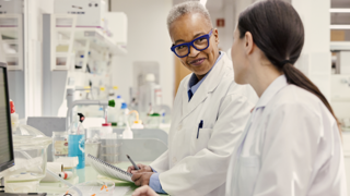 Person working in a lab wearing safety glasses