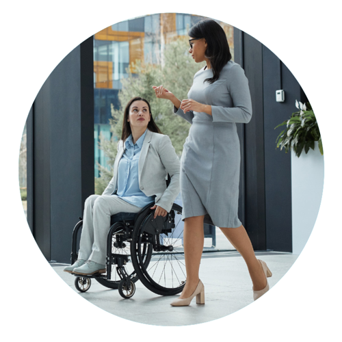 Two people talking - one in wheelchair, one walking