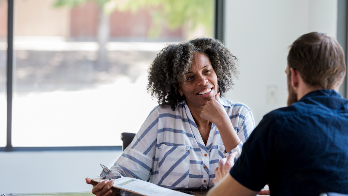 Two coworkers sitting and talking 