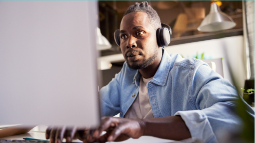 Man sitting at computer typing on keyboard