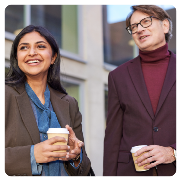 Photo of two people holding coffee cups