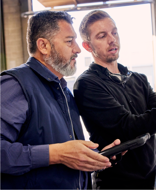 Two men working together in a manufacturing building